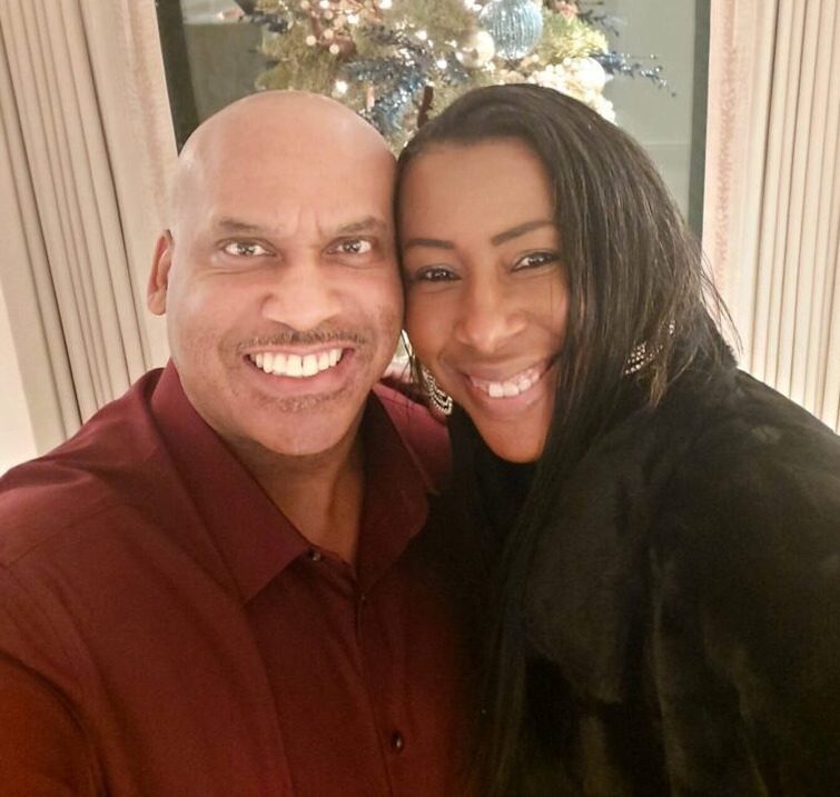 Smiling couple taking a selfie indoors.